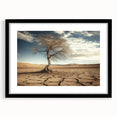 Black-framed landscape artwork depicting a serene desert scene with warm colors and a white mat, ideal for home decor or gallery displays.