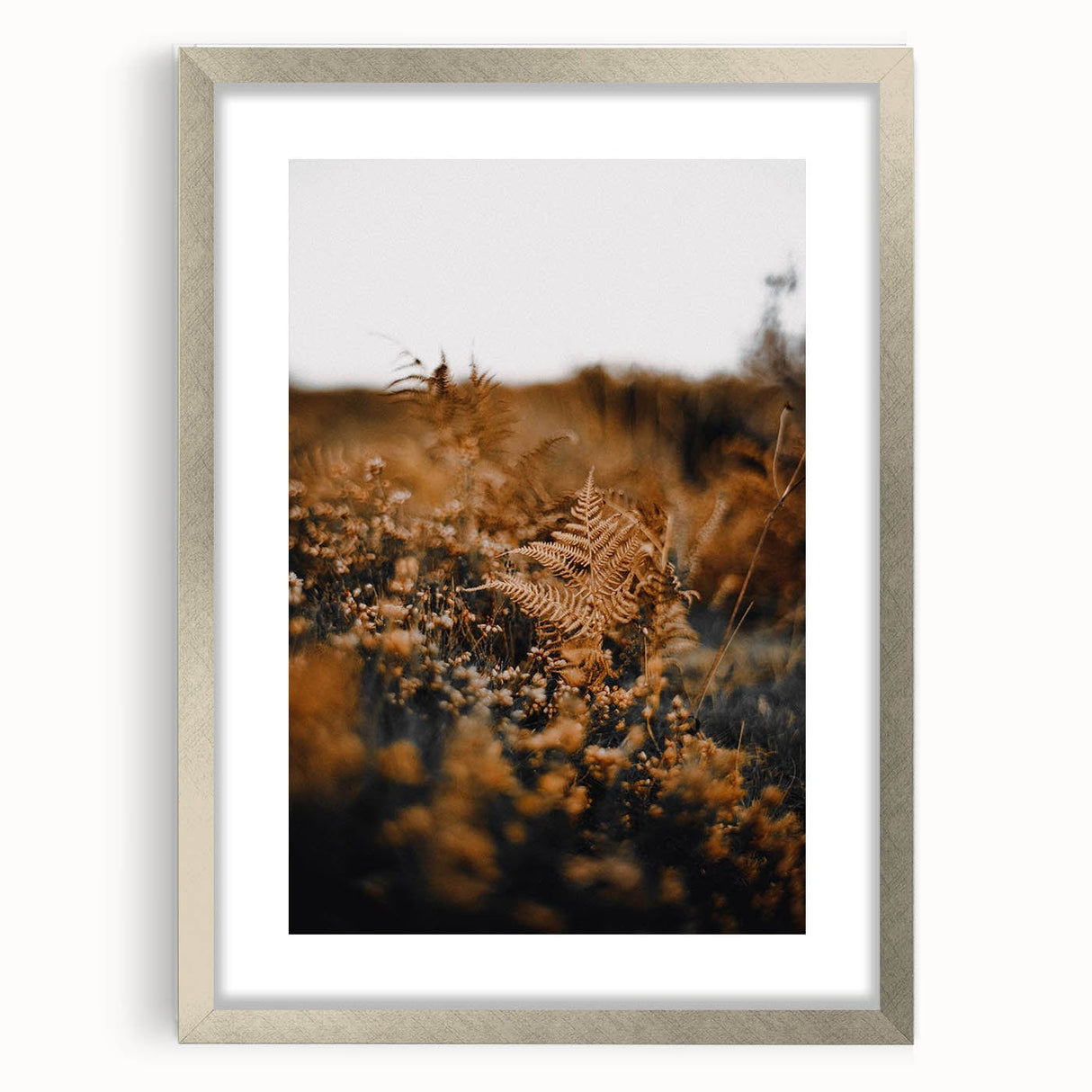 Textured abstract art print depicting autumn colors in a silver frame, ideal for bedroom art.