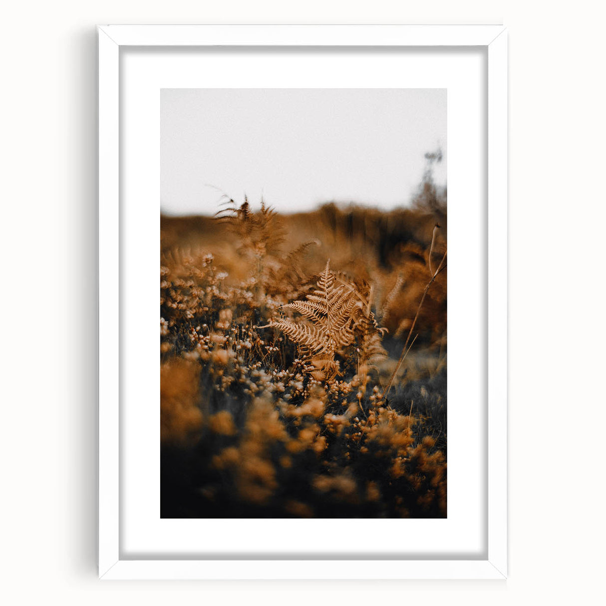 Abstract art print featuring autumnal hues in a white frame, ideal for dining room or bedroom decor.