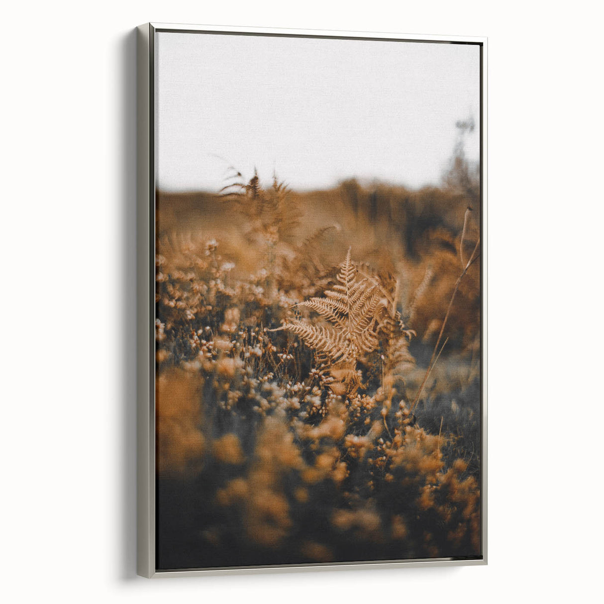 Framed canvas landscape art depicting fall foliage in muted earth tones.
