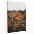Side view of a large stretched canvas featuring a fall-themed abstract design in warm orange and red tones.