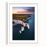 Framed landscape artwork showcasing dramatic cliffs against a serene sky, presented with a white mat for an elegant finish, perfect for home decor.
