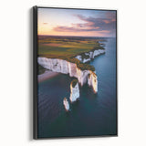 Framed canvas artwork depicting a dramatic cliff landscape with vibrant colors, showcasing a black frame accentuating the scenic view. Ideal for nature-inspired decor.