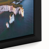 Close-up of a framed canvas showcasing a vibrant landscape of rugged cliffs under a clear blue sky, emphasizing natural beauty and artistic detail. Perfect for home decor.