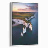 Framed canvas artwork depicting dramatic cliffs and landscapes, showcasing vibrant colors and intricate details, presented in a white frame for an elegant display.