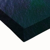 Close-up of a stretched canvas artwork depicting vibrant landscapes and rugged cliffs, showcasing rich colors and intricate details, perfect for home decor.