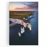 Stretched canvas artwork depicting a dramatic landscape of towering cliffs under a vibrant sunset, showcasing rich colors and intricate details, perfect for home decor.