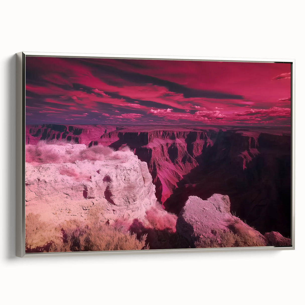 Framed canvas artwork depicting a stunning landscape of canyons, showcasing vibrant colors and intricate details, presented in a sleek silver frame, perfect for home decor.