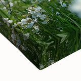 Close-up of a stretched canvas print showcasing a vibrant countryside landscape with rolling hills, lush greenery, and a dramatic sky, ideal for home decor.