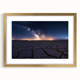 Elegant desert landscape framed in gold with a mat, showcasing vibrant hues of orange and blue in a serene sunset scene, perfect for home decor.