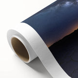 Desert landscape rolled canvas artwork showcasing vibrant hues of orange and yellow sand dunes under a clear blue sky, elegantly packaged for wall display.