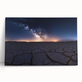 Desert landscape canvas print featuring warm earth tones and vibrant sunset hues, elegantly leaning against a wall, perfect for home decor and art enthusiasts.