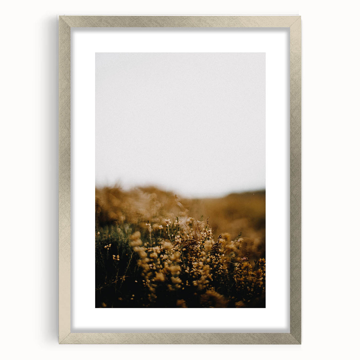 Textured abstract art print in warm autumnal tones on a framed silver canvas, ideal for bedroom ambiance.