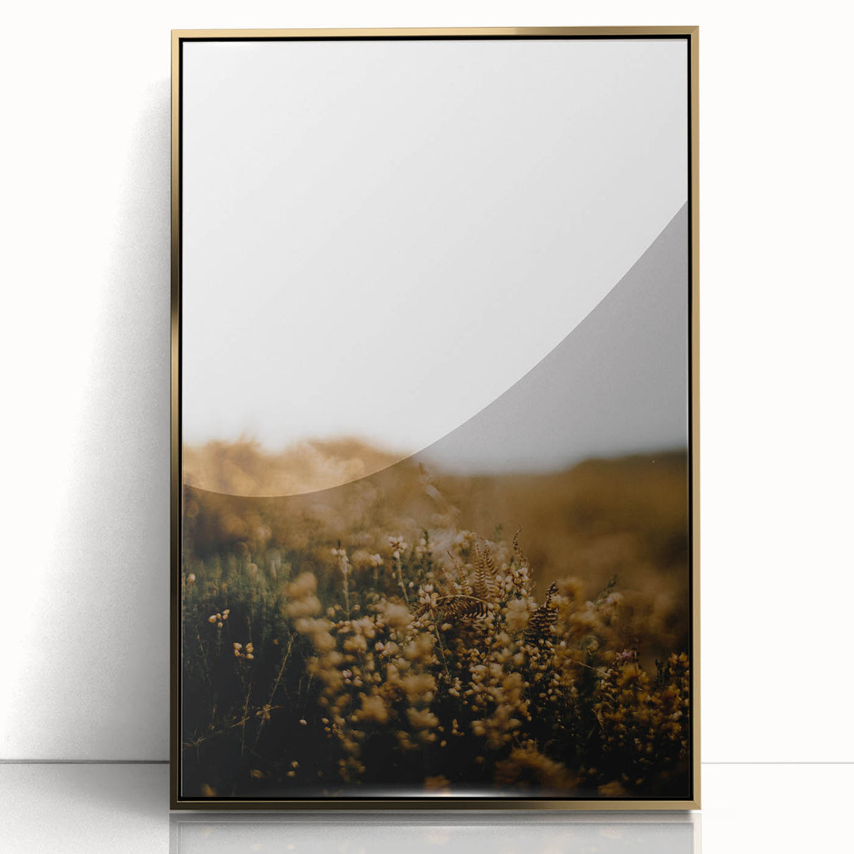 Acrylic print of fall trees in gold and orange tones, framed in gold, in a mid-century modernist style.
