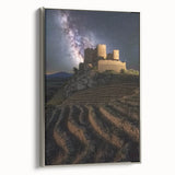 Framed canvas artwork showcasing a detailed landscape with a majestic castle under a vibrant sky, enhanced by a sleek silver frame, perfect for home decor.