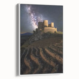 Framed canvas artwork showcasing a picturesque landscape of a castle surrounded by lush greenery, displayed in a sleek white frame, ideal for home decor.