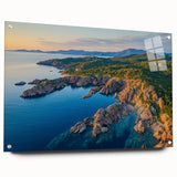 Stunning acrylic landscape artwork depicting dramatic cliffs, showcased in a sleek glass frame, with metal pins for secure display, perfect for modern decor.