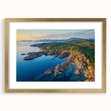 Elegant gold-framed landscape artwork depicting majestic cliffs, enhanced by a mat for depth, perfect for home decor or gallery display.
