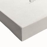 Close-up of a large art piece featuring a black and white landscape painting of fruits on stretched canvas.