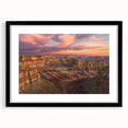 Framed landscape art featuring dramatic canyons in shades of orange and brown, accented with a sleek black mat. Ideal for enhancing modern home decor.
