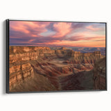 Framed canvas artwork depicting a stunning landscape of canyons, showcasing rich earthy tones and intricate details, presented in a sleek black frame, ideal for home decor.