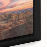 Close-up of a framed canvas artwork showcasing a dramatic canyon landscape, featuring vibrant earthy tones and intricate textures, ideal for home decor enhancement.