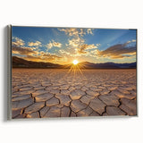 Framed canvas artwork depicting a serene desert landscape with soft hues of orange and gold, highlighted by a sleek silver frame, ideal for home decor.