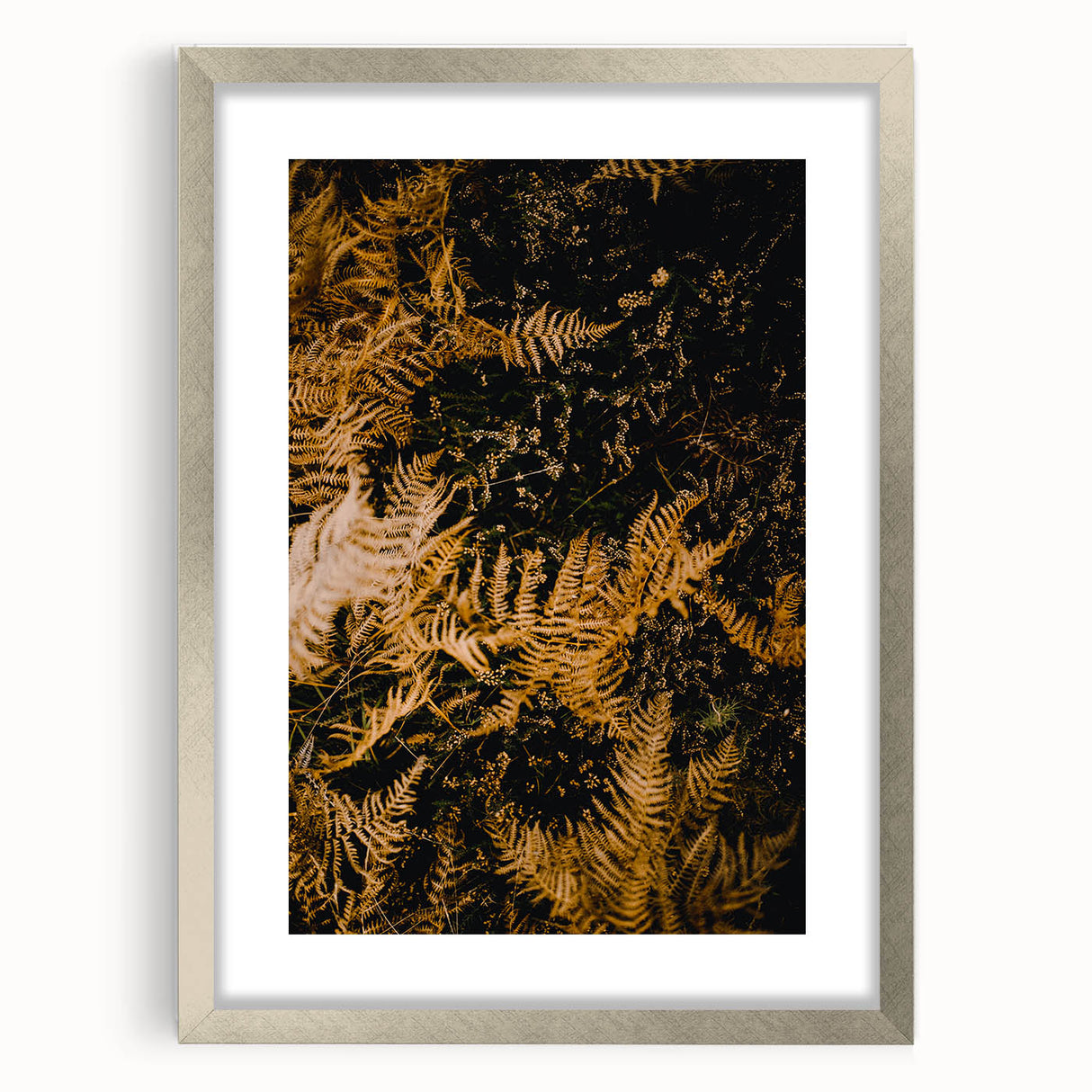 Textured abstract art print in warm autumn hues on a silver-framed canvas, suitable for bedroom decor.
