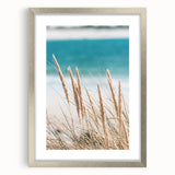 Textured abstract art print in warm orange and red tones on a silver-framed canvas, ideal for bedroom ambiance.