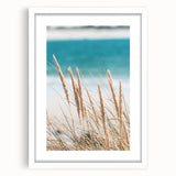 Abstract art print featuring swirling blue and green patterns, framed in white, ideal for dining room decor.