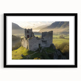 Elegant black-framed landscape artwork depicting a majestic castle surrounded by lush greenery, featuring a white mat for an enhanced presentation. Perfect for home decor.