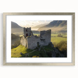 Elegant silver-framed landscape artwork depicting a majestic castle surrounded by lush greenery, enhanced with a white mat for a sophisticated finish. Perfect for home decor.
