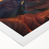 Vibrant landscape canvas print showcasing colorful canyons in rich reds and oranges, rolled and ready for display in an artful setting. Ideal for enhancing interior decor.