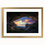Framed landscape artwork depicting a serene cave scene, presented with an elegant gold mat and frame, ideal for enhancing home decor and art collections.