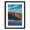 Framed black landscape artwork depicting rugged cliffs, elegantly matted, showcasing intricate textures and shadows, perfect for modern home decor.
