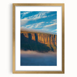 Framed landscape artwork depicting dramatic cliffs with a gold mat, showcasing intricate details and vibrant colors, perfect for enhancing home decor.