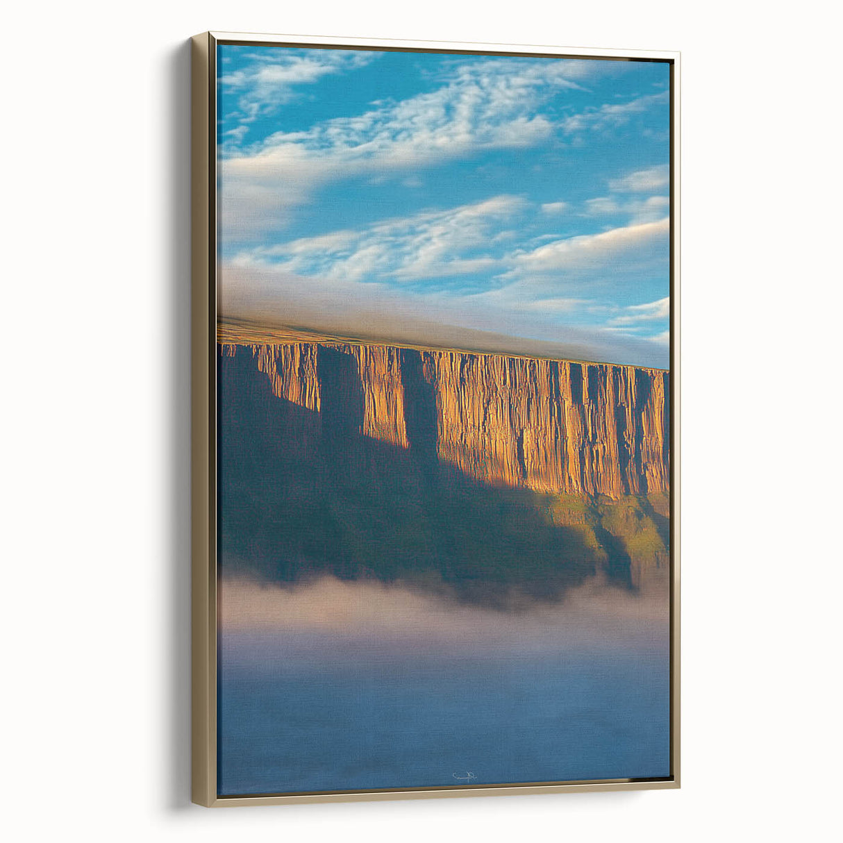 Framed canvas artwork depicting a stunning landscape of rugged cliffs with golden accents, showcasing a side view that enhances its depth and texture.