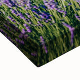 Close-up of a vibrant stretched canvas showcasing a picturesque countryside landscape with rolling hills and a clear blue sky, ideal for home decor.