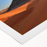 Desert landscape rolled canvas art showcasing vibrant hues of orange and yellow under a clear blue sky, elegantly packaged in a protective cardboard tube.