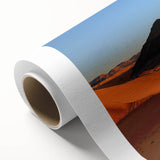 Rolled canvas showcasing a vibrant desert landscape design with warm earth tones, ideal for home decor, packaged securely in a durable cardboard tube for safe shipping.