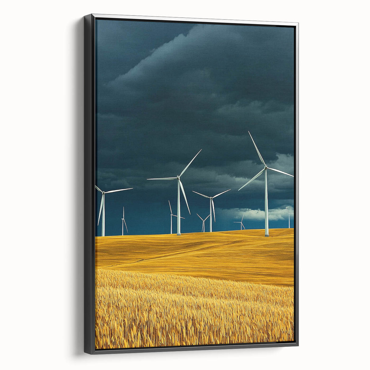 Framed canvas artwork depicting a serene landscape of rolling fields in vibrant greens and golds, showcased from a black side view, ideal for home decor.