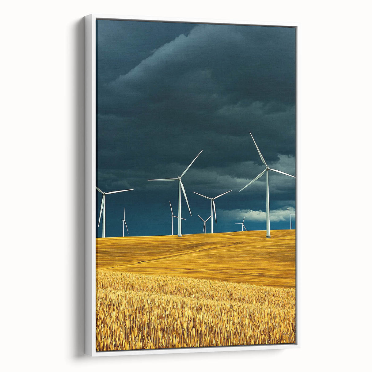 Framed canvas artwork showcasing a serene landscape of rolling fields in soft greens and yellows, with a white frame accentuating the scene's tranquility.