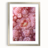 Textured art print featuring abstract nature elements in muted green and brown tones, framed in silver.