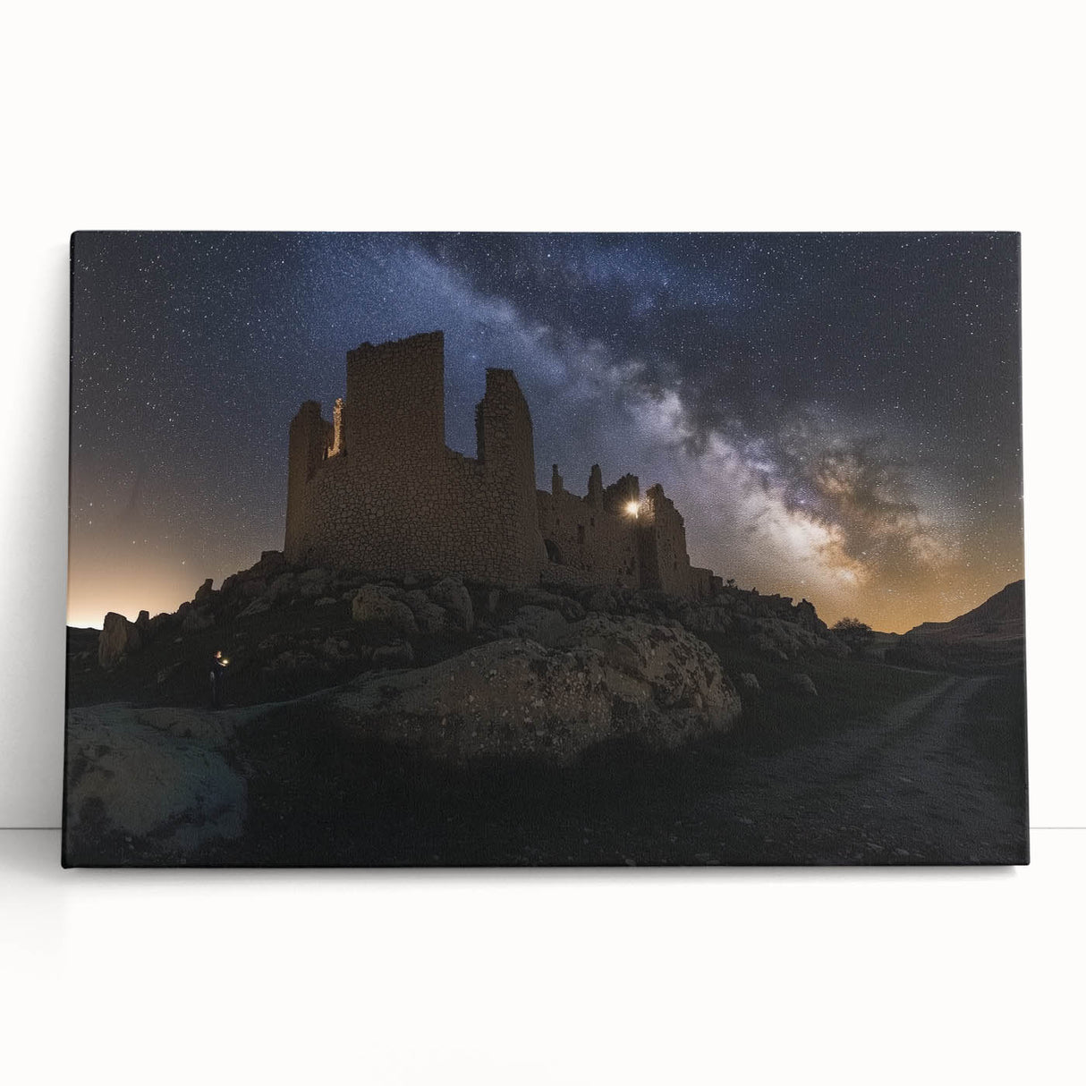 Stretched canvas artwork depicting a serene landscape with a majestic castle surrounded by lush greenery and a vibrant sunset sky, perfect for home decor.