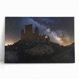 Stretched canvas artwork depicting a serene landscape with a majestic castle surrounded by lush greenery and a vibrant sunset sky, perfect for home decor.