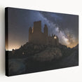 Stretched canvas artwork depicting a serene landscape with a majestic castle surrounded by lush greenery and a clear blue sky, ideal for home decor.