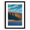Framed landscape artwork showcasing dramatic cliffs in a black mat, ideal for home decor. Perfect for adding a touch of nature-inspired elegance to any room.
