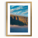 Framed landscape artwork depicting majestic cliffs in natural hues, featuring a gold mat and frame, ideal for enhancing home decor with elegance.
