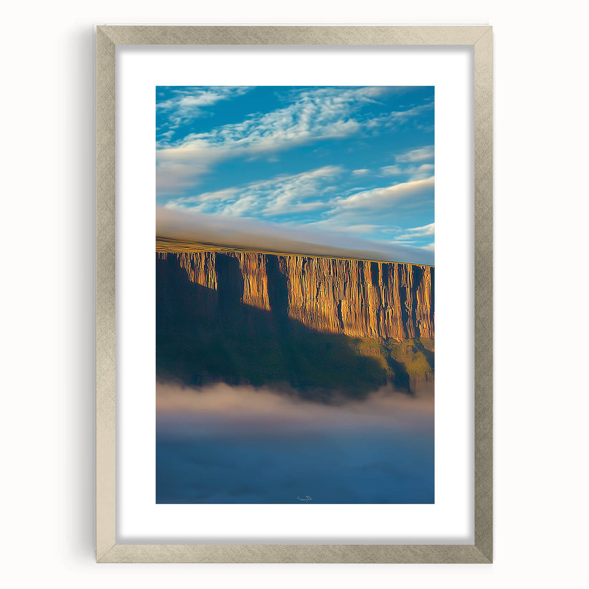 Silver-framed landscape artwork depicting majestic cliffs, elegantly matted for a refined look. Perfect for home decor or office enhancement, showcasing natural beauty.