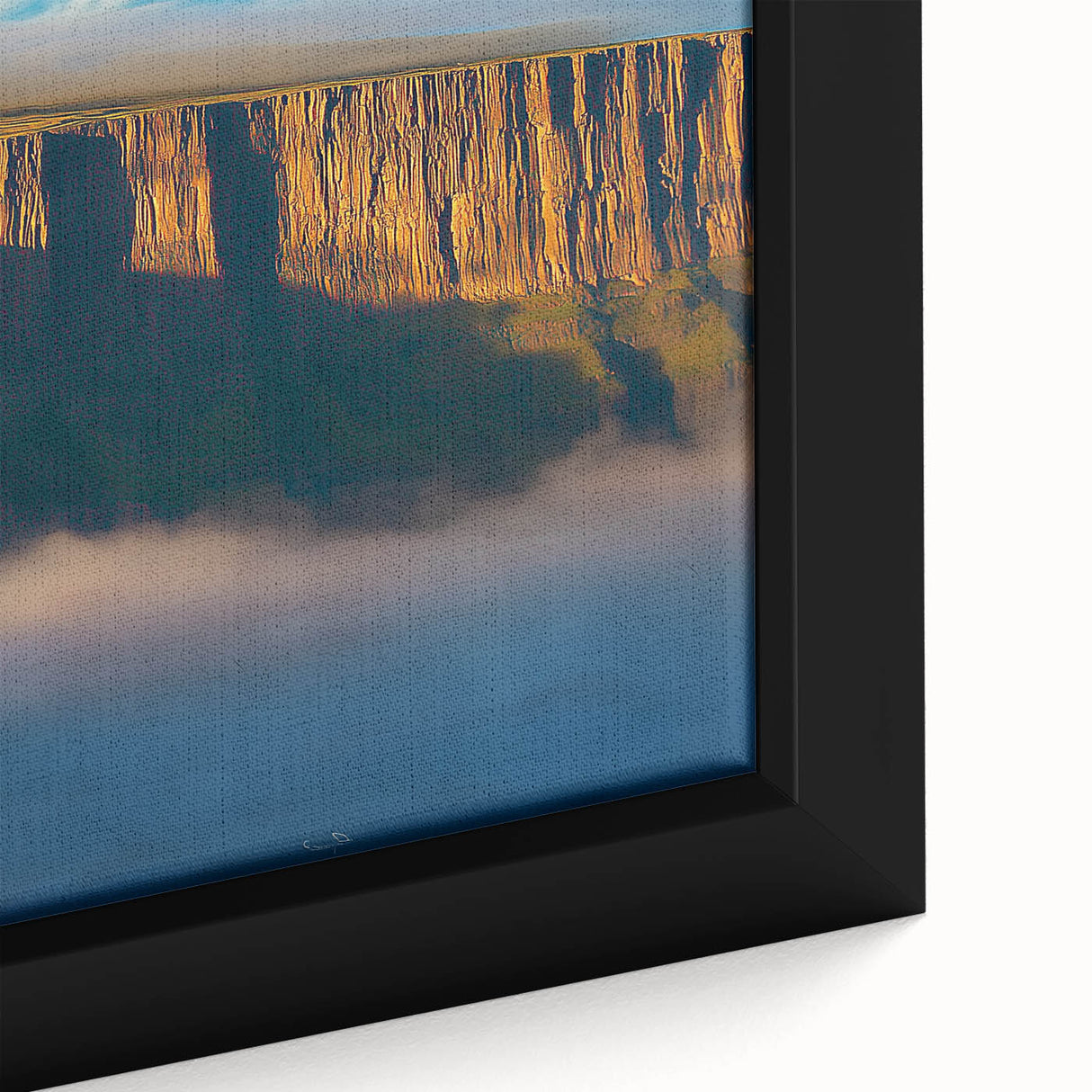 Close-up of a beautifully framed canvas artwork depicting dramatic cliffs and serene landscapes, showcasing rich colors and intricate details for an elegant home decor accent.
